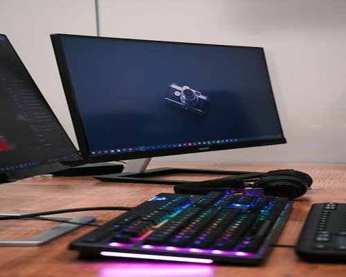 Minimalist tech desk setup displaying a glowing monitor with balanced warm backlighting